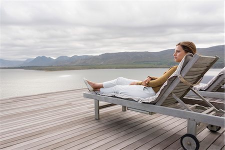 deck - Beautiful woman relaxing at lakeshore Stock Photo - Premium Royalty-Free, Code: 6108-08662933