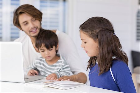 simsearch:6102-08942558,k - Father teaching to children about world map while using laptop at home Stock Photo - Premium Royalty-Free, Code: 6108-08663152