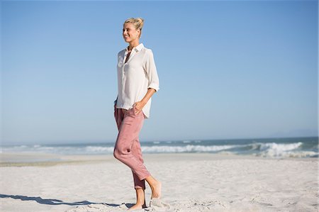 simsearch:6108-08662619,k - Beautiful young woman walking on sunny beach Stock Photo - Premium Royalty-Free, Code: 6108-08663377