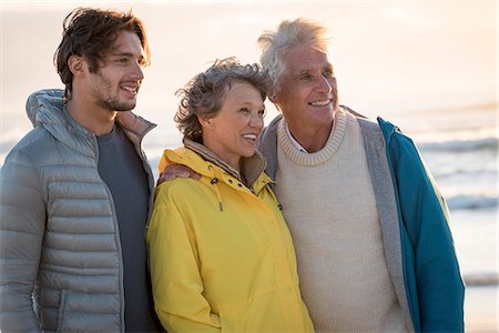 senior parent and son and adults only - Happy family standing on the beach Stock Photo - Premium Royalty-Free, Code: 6108-08663301