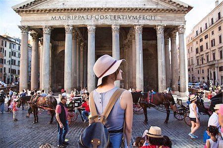 Young woman standing in profile, contemplates the Roman Pantheon Stock Photo - Premium Royalty-Free, Code: 6108-08637217