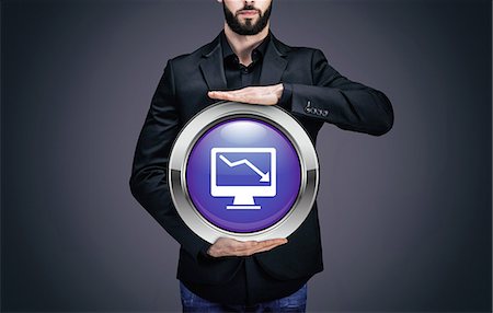 simsearch:6108-08637343,k - Businessman holding a circle containing the symbol "Computer" Stock Photo - Premium Royalty-Free, Code: 6108-08637355