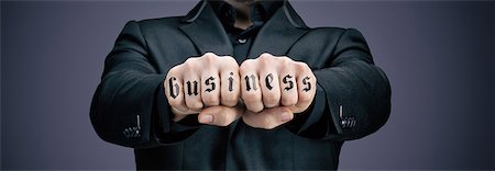 emotional vitality - Businessman tattooed fists Stock Photo - Premium Royalty-Free, Code: 6108-08637358