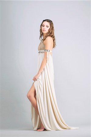 simsearch:6108-08637199,k - Young woman standing in profile, wearing a beige dress "Sanhadja" Stock Photo - Premium Royalty-Free, Code: 6108-08637374