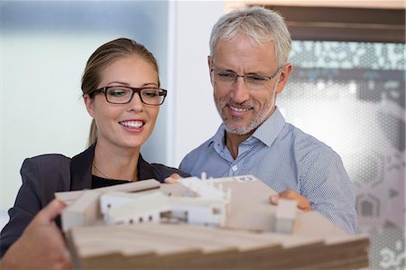 designer headshot - Design professionals examining architectural model in an office Photographie de stock - Premium Libres de Droits, Code: 6108-08725285