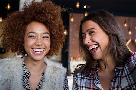 Portrait of happy female friends having fun in cafe Stock Photo - Premium Royalty-Free, Code: 6108-08725290