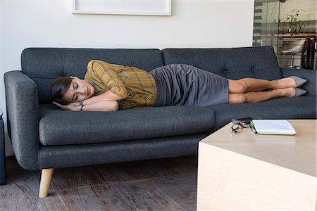 sofa woman resting - Business relaxing on a couch during office break Stock Photo - Premium Royalty-Free, Code: 6108-08725220