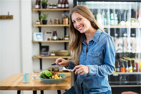 Portrait of a happy woman having lunch in a restaurant Stock Photo - Premium Royalty-Free, Code: 6108-08725230