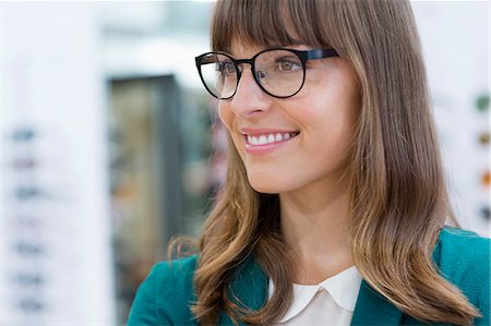 simsearch:6108-05868342,k - Happy young businesswoman smiling in office Photographie de stock - Premium Libres de Droits, Code: 6108-08725407