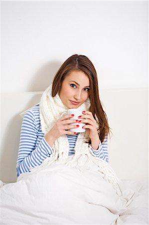 drinking healthy tea - Young woman sick on bed Stock Photo - Premium Royalty-Free, Code: 6108-08908970