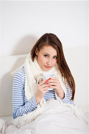 drinking tea - Young woman sick on bed Stock Photo - Premium Royalty-Free, Code: 6108-08908971