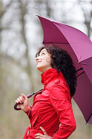 raining sky - Woman enjoying a walk in the park in Winter Stock Photo - Premium Royalty-Free, Code: 6108-08908991