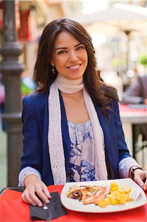 Portrait of a brunette woman having lunch in a restaurant outdoor Stock Photo - Premium Royalty-Free, Code: 6108-08909053