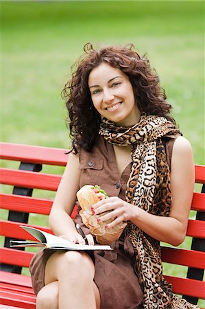 Businesswoman sitting in a bench in a Park in the pause from work Stock Photo - Premium Royalty-Free, Code: 6108-08909002