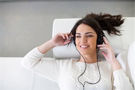 simsearch:640-08089386,k - Pretty woman with headphones on the sofa Stock Photo - Premium Royalty-Free, Code: 6108-08909144