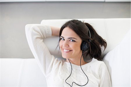simsearch:640-08089386,k - Pretty woman with headphones on the sofa Stock Photo - Premium Royalty-Free, Code: 6108-08909146