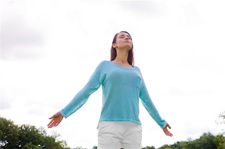 relief face - Pretty woman stretching in the park Stock Photo - Premium Royalty-Free, Code: 6108-08909248