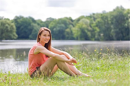 secluded lake woman - Woman relaxing by a lake Stock Photo - Premium Royalty-Free, Code: 6108-08909256