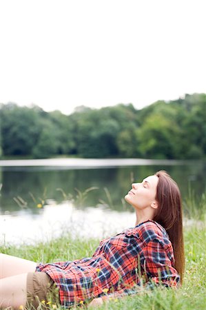 simsearch:6108-05859110,k - Woman relaxing by a lake Stock Photo - Premium Royalty-Free, Code: 6108-08909263