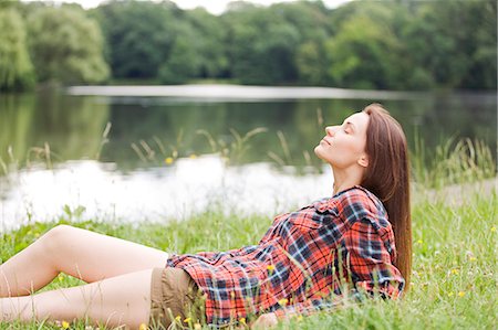 secluded lake woman - Woman relaxing by a lake Stock Photo - Premium Royalty-Free, Code: 6108-08909262