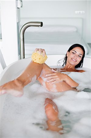 Young pretty brunette woman enjoying a bath Stock Photo - Premium Royalty-Free, Code: 6108-08909601