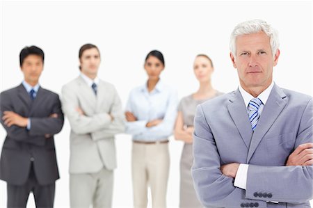 simsearch:6109-06002664,k - Close-up of a multicultural business team with their arms folded focus on a white hair man in foreground Foto de stock - Sin royalties Premium, Código: 6109-06002653
