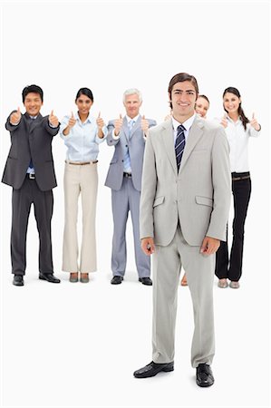 simsearch:6109-06002664,k - Multicultural business team with their thumbs-up focus on a smiling man in foreground against white background Foto de stock - Sin royalties Premium, Código: 6109-06002673