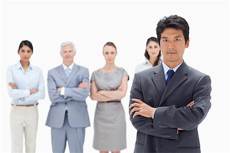 simsearch:6109-06002664,k - Close-up of a business team crossing their arms with an Asian man in foreground against white background Foto de stock - Sin royalties Premium, Código: 6109-06002691