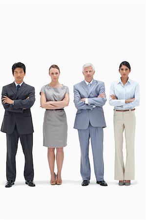 Serious multicultural business team with their arms folded against white background Stock Photo - Premium Royalty-Free, Code: 6109-06002615