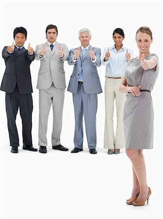 simsearch:6109-06002781,k - Multicultural business team with their thumbs-up with a smiling woman in foreground against white background Foto de stock - Sin royalties Premium, Código: 6109-06002632