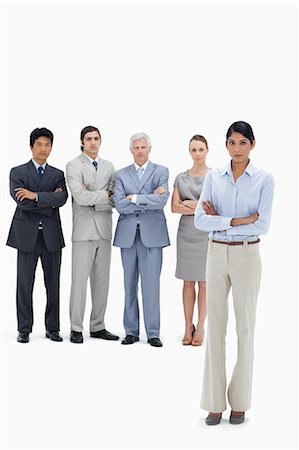 Serious multicultural business team with their arms folded with a woman in foreground against white background Stock Photo - Premium Royalty-Free, Code: 6109-06002637