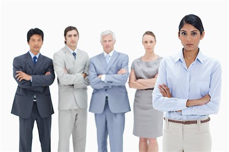 simsearch:6109-06002664,k - Close-up of a serious multicultural business team with their arms folded with a woman in foreground against white background Foto de stock - Sin royalties Premium, Código: 6109-06002636