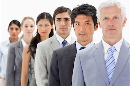 Close-up of business people in a single line with focus on the second person against white background Stock Photo - Premium Royalty-Free, Code: 6109-06002747