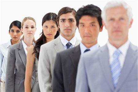en fila india - Close-up of business people in a single line with focus on the fifth person against white background Foto de stock - Sin royalties Premium, Código: 6109-06002750