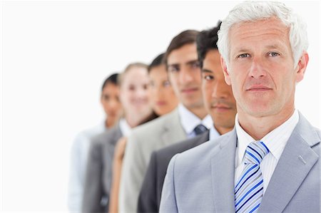 people queue - Close-up of a single line of business people with focus on the first person against white background Stock Photo - Premium Royalty-Free, Code: 6109-06002757