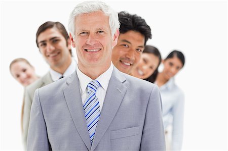 simsearch:6109-06002847,k - Business people smiling in a single line against white background Foto de stock - Royalty Free Premium, Número: 6109-06002760