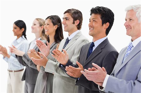 Happy multicultural business people applauding against white background Stock Photo - Premium Royalty-Free, Code: 6109-06002762
