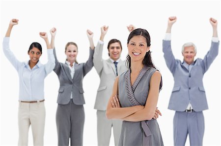 simsearch:6109-06002781,k - Close-up of a smiling woman with a business team raising their arms against white background Foto de stock - Sin royalties Premium, Código: 6109-06002780