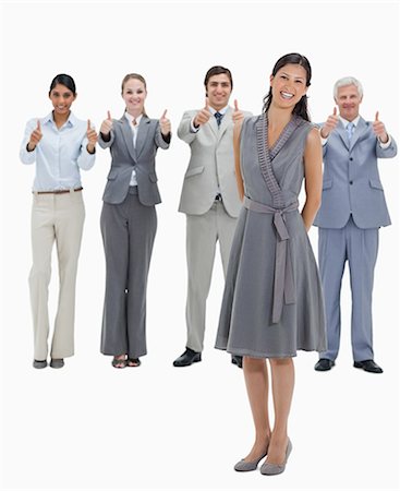 simsearch:6109-06002803,k - Laughing woman with a business team with their thumbs-up against white background Stock Photo - Premium Royalty-Free, Code: 6109-06002782