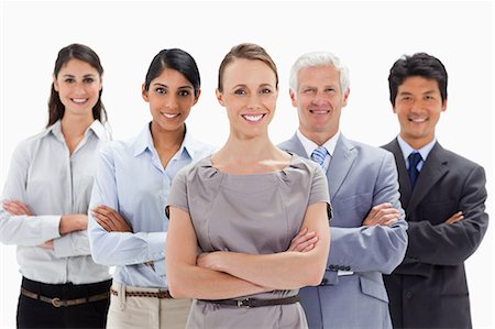 simsearch:6109-06002664,k - Close-up of a smiling business team with their arms folded against white background Foto de stock - Sin royalties Premium, Código: 6109-06002727