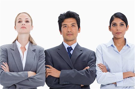 simsearch:6109-06002847,k - Business people with their arms folded looking into the distance against white background Foto de stock - Royalty Free Premium, Número: 6109-06002856