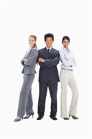 Businessman surrounding by two smiling women against white background Stock Photo - Premium Royalty-Free, Code: 6109-06002860