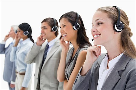 Smiling professionals with headsets against white background Stock Photo - Premium Royalty-Free, Code: 6109-06002809