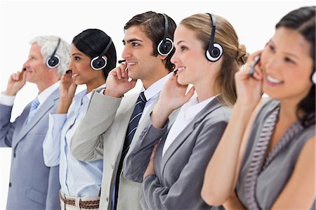 simsearch:6109-06002826,k - Smiling professionals listening wearing a headsets against white background Stock Photo - Premium Royalty-Free, Code: 6109-06002817