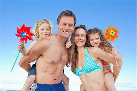 piggy back ride - Playful young family enjoying their time together on the beach Stock Photo - Premium Royalty-Free, Code: 6109-06003650