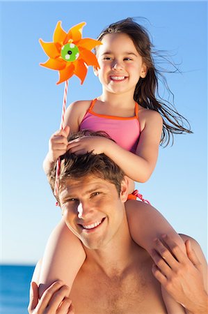 Happy father on the beach with his little daughter on his shoulders Foto de stock - Sin royalties Premium, Código: 6109-06003797