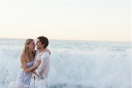 summer beach break - Young couple getting hit by wave Stock Photo - Premium Royalty-Free, Code: 6109-06003840