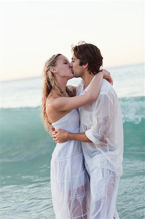 Kissing young couple standing in the sea Stock Photo - Premium Royalty-Free, Code: 6109-06003844