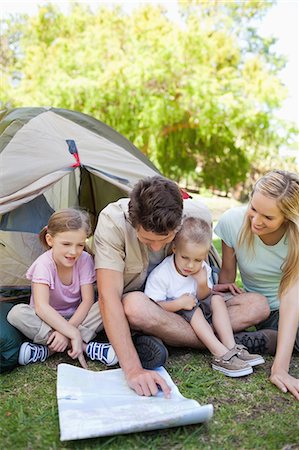 A camping family look at the map to see where they are. Stock Photo - Premium Royalty-Free, Code: 6109-06003870