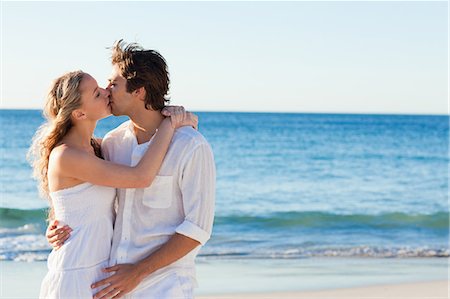 Young couple kissing on the beach Stock Photo - Premium Royalty-Free, Code: 6109-06003801